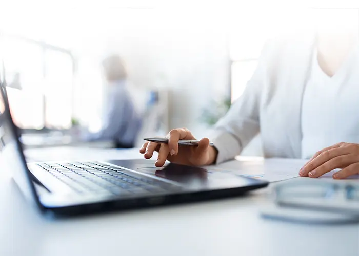 Image of person working at a laptop.